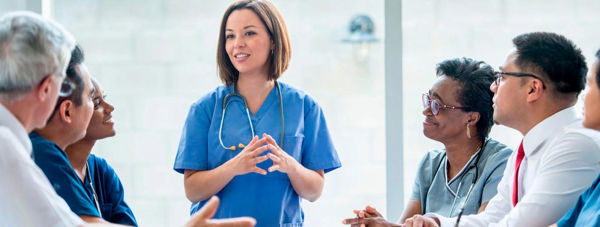 A nurse presenting to a group of healthcare leaders