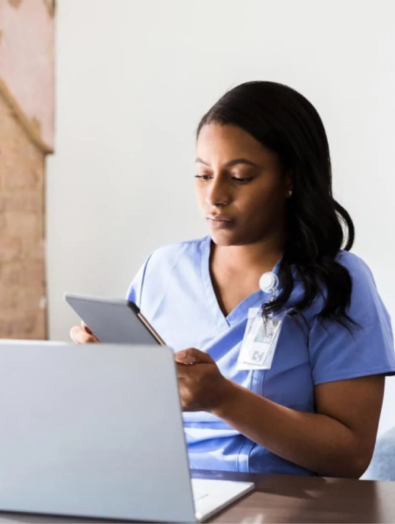 A nurse working at a laptop